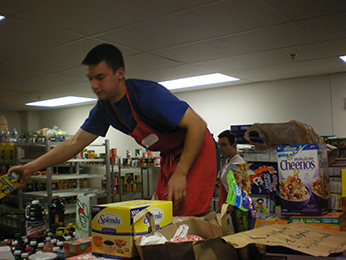 Mr Marc Valentin, CSC helping with food pantry