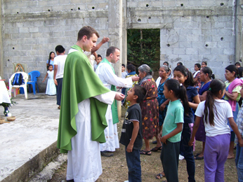 Fr Aaron Michka, CSC giving communion